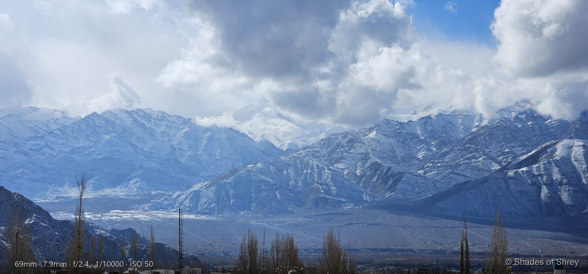 Towering snow-capped Himalayan peaks piercing through clouds