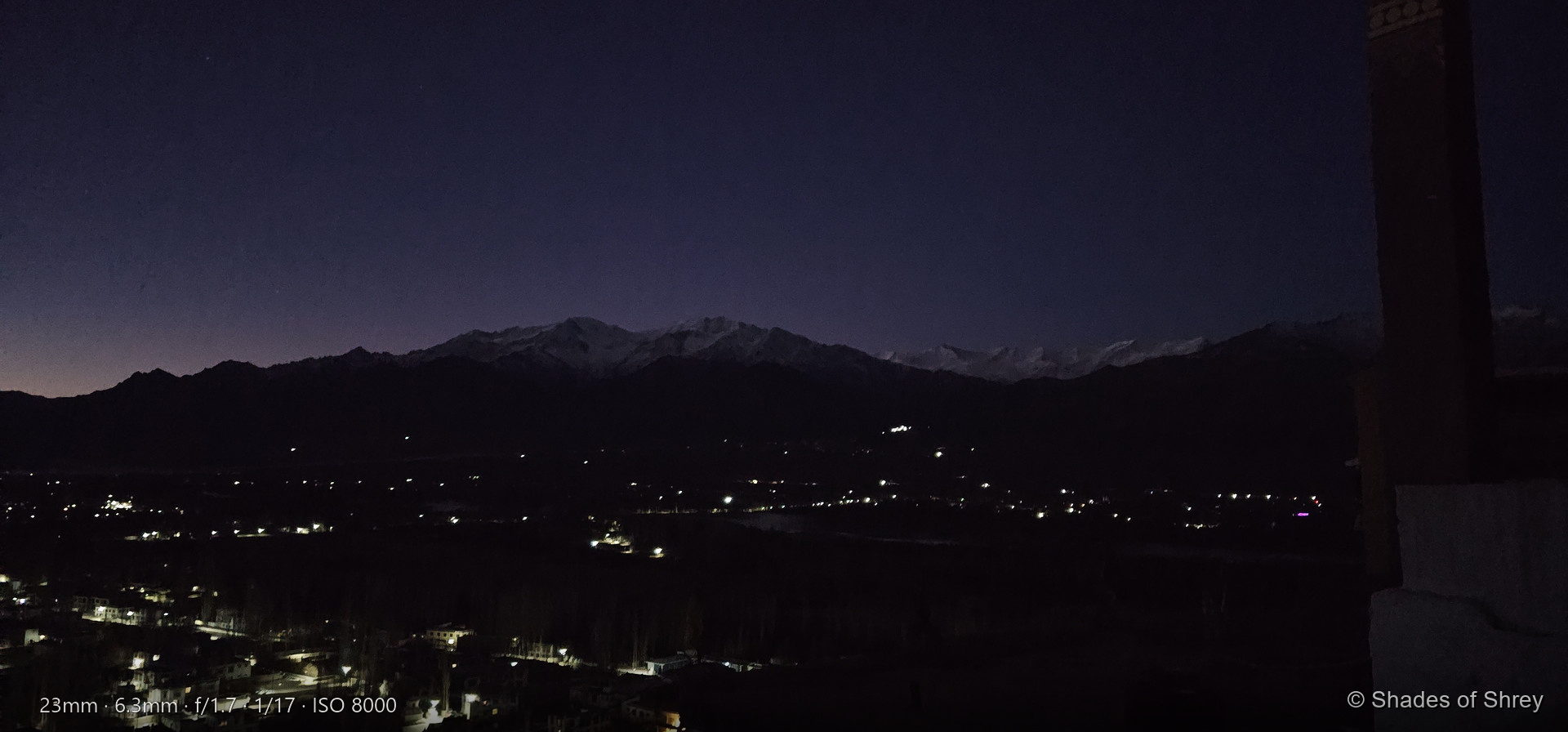 Dawn breaking over Leh valley from Thiksey Monastery, Ladakh — snow-capped peaks under pre-dawn sky