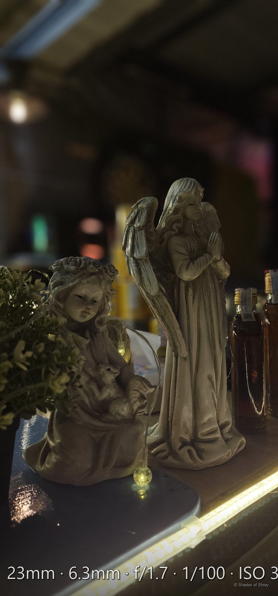Stone angel statues illuminated at night outside a Bangkok cathedral