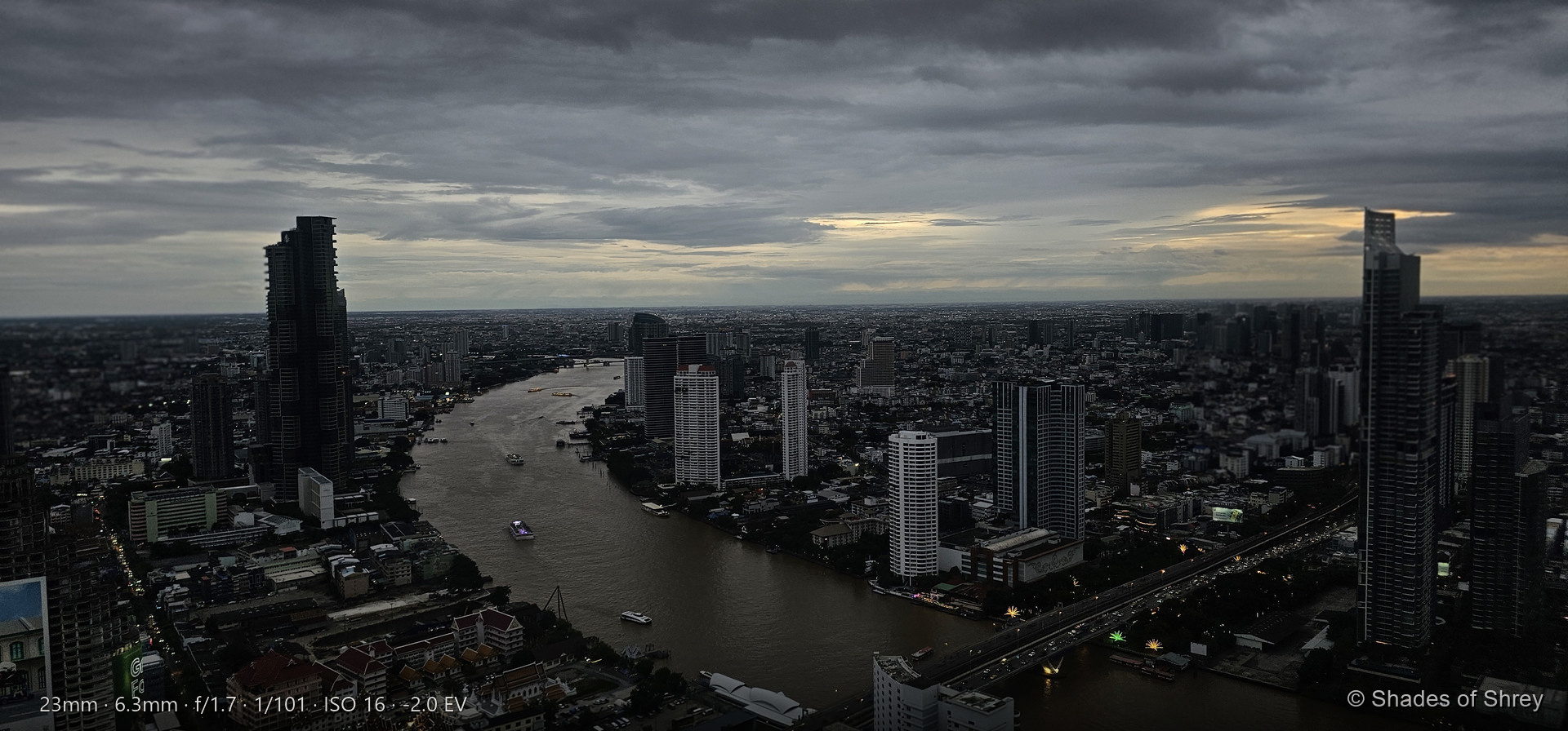Chao Phraya River winding through Bangkok at dusk, seen from above